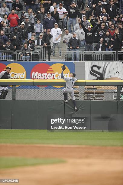 Eric Byrnes of the Seattle Mariners leaps but cannot catch the ball hit by Alexei Ramirez of the Chicago White Sox during the fifth inning on April...