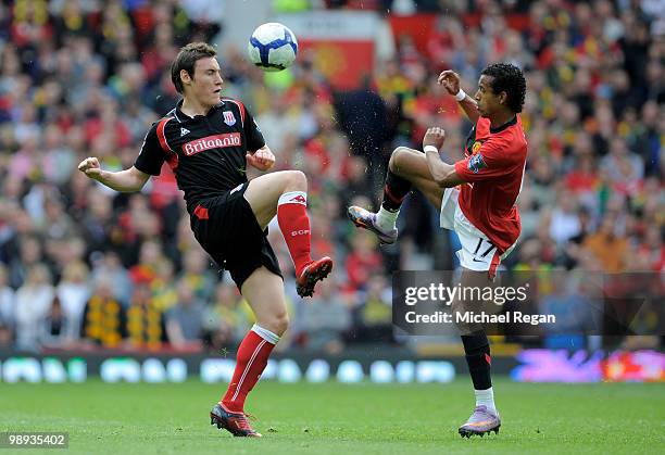 Dean Whitehead of Stoke City competes for the ball with Nani of Manchester United during the Barclays Premier League match between Manchester United...