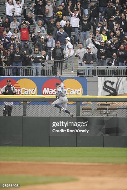 Eric Byrnes of the Seattle Mariners leaps but cannot catch the ball hit by Alexei Ramirez of the Chicago White Sox during the fifth inning on April...