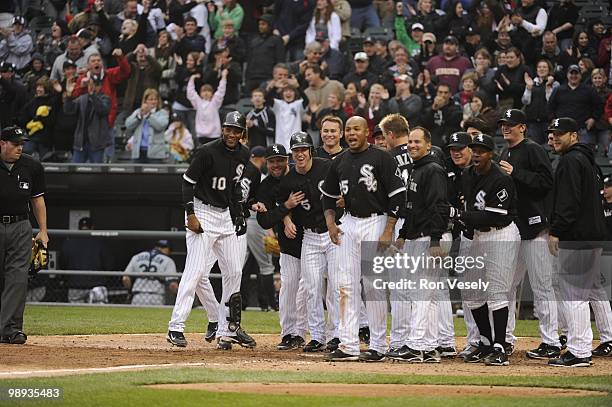 The White Sox gather at home plate to greet Alex Rios of the Chicago White Sox after Rios hit a walk-off, two-run home run against David Aardsma of...