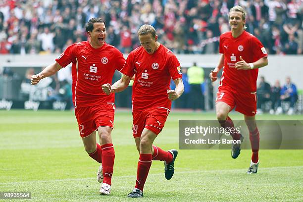 Marcel Gaus of Duesseldorf celebrates with team mate Christian Weber after scoring the first goal during the Second Bundesliga match between Fortuna...