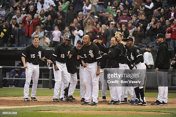 The White Sox gather at home plate to greet Alex Rios of the Chicago White Sox after Rios hit a walk-off, two-run home run against David Aardsma of...