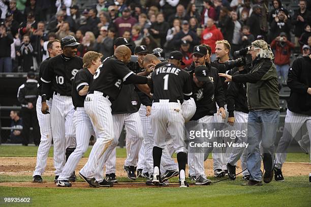 Teammates mob Alex Rios the Chicago White Sox after Rios hit a walk-off, two-run home run against David Aardsma of the Seattle Mariners on April 24,...