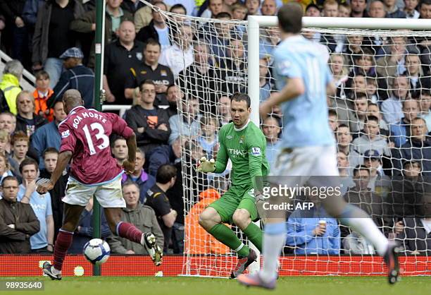 West Ham United's Portuguese player Luis Boa Morte scores the opening goal past Manchester City's on-loan Hungarian goalkeeper Marton Fulop during...