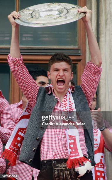Thomas Mueller of Bayern Muenchen and his teammates celebrate the German championship title on the balcony of the town hall on May 9, 2010 in Munich,...