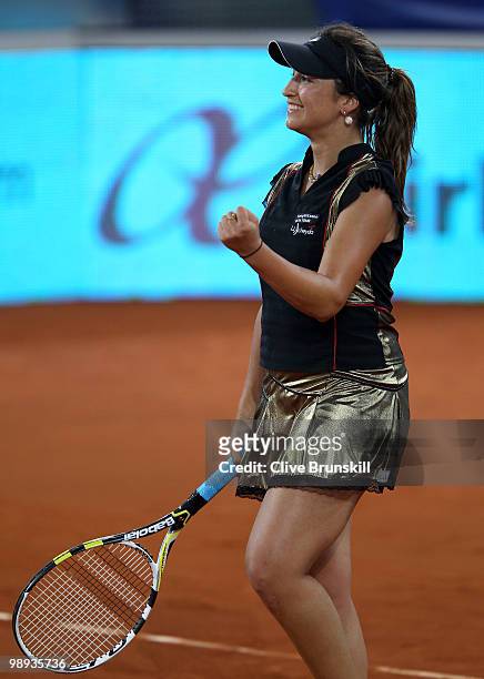 Aravane Rezai of France celebrates match point against Justin Henin of Belgium in their first round match during the Mutua Madrilena Madrid Open...