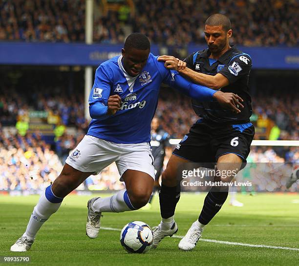 Victor Anichebe of Everton and Hayden Mullins of Portsmouth challenge for the ball during the Barclays Premier League match between Everton and...