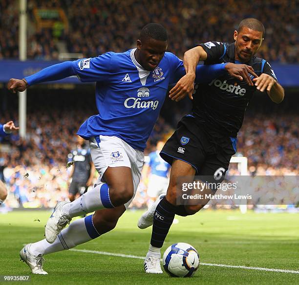 Victor Anichebe of Everton and Hayden Mullins of Portsmouth challenge for the ball during the Barclays Premier League match between Everton and...