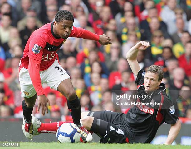 Patrice Evra of Manchester United clashes with Robert Huth of Stoke City during the Barclays Premier League match between Manchester United and Stoke...