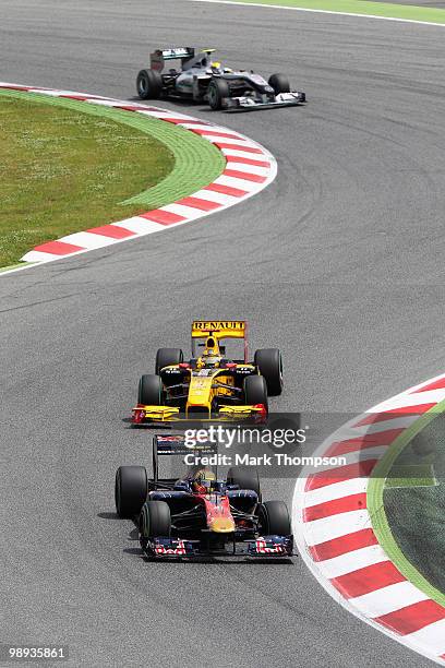 Jaime Alguersuari of Spain and Scuderia Toro Rosso leads from Robert Kubica of Poland and Renault during the Spanish Formula One Grand Prix at the...