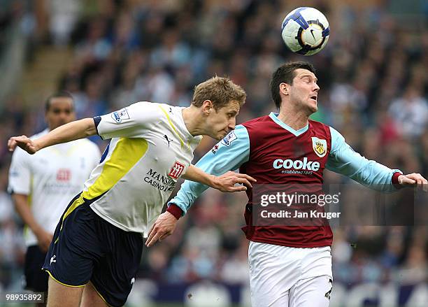 Michael Dawson of Tottenham Hotspur heads clear of David Nugent of Burnley during the Barclays Premier League match between Burnley and Tottenham...