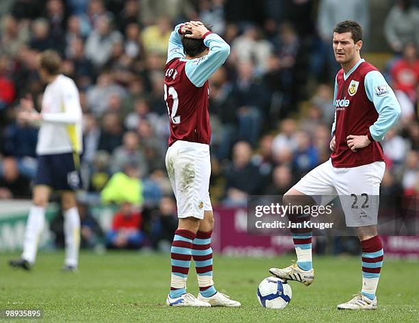 David Nugent and Jack Cork of Burnley look dejected as Spurs celebrate their second goal during the Barclays Premier League match between Burnley and...