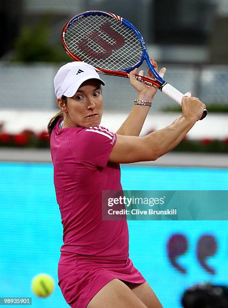 Justin Henin of Belgium plays a backhand against Aravane Rezai of France in their first round match during the Mutua Madrilena Madrid Open tennis...