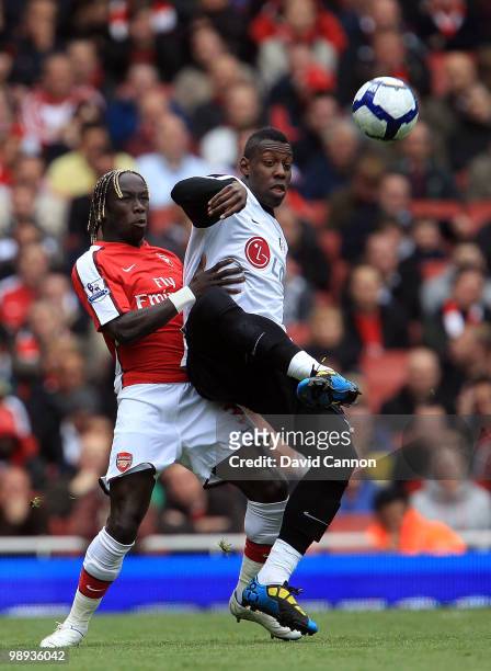 Stefano Okaka of Fulham is tackeld by Bacary Sagna of Arsenal during the Barclays Premier League match between Arsenal and Fulham at The Emirates...