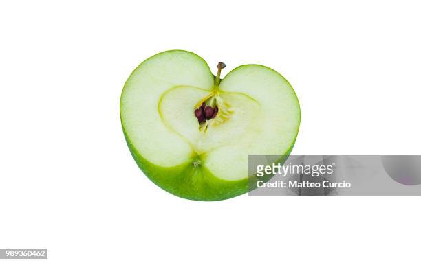 green granny smith apple cut in half on white background - granny smith stock pictures, royalty-free photos & images