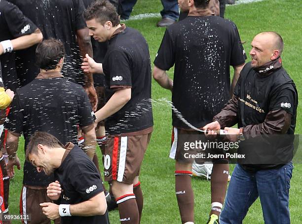 Head coach Holger Stanislawski of St. Pauli celebrates with beer after the Second Bundesliga match between FC St. Pauli and SC Paderborn at...