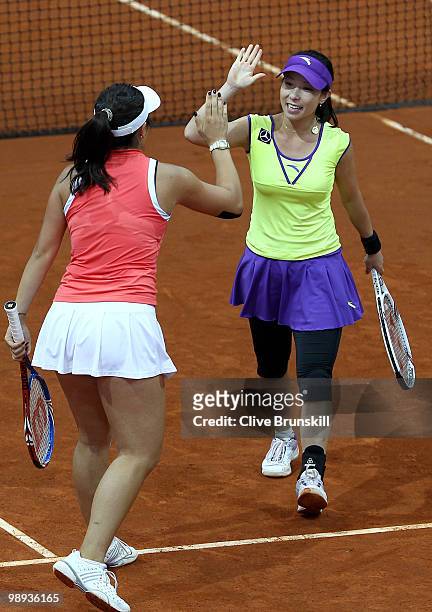 Yung-Jan Chan of Taipei and Jie Zheng of China celebrate victory against Cara Black of Zimbabwe and Elena Vesnina of Russia in their first round...