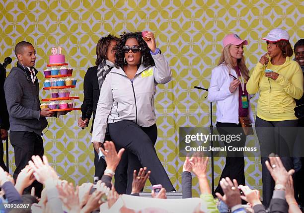 Media personality Oprah Winfrey holds up a cupcake in celebration of the completion of the "Live Your Best Life Walk" to celebrate O, The Oprah...