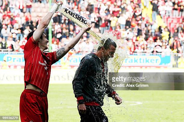 Head coach Marco Kurz of Kaiserslautern is showered with beer by Srdjan Lakic after the Second Bundesliga match between 1. FC Kaiserslautern and FC...
