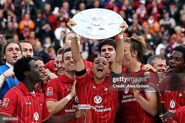 Sidney Sam of Kaiserslautern holds up the championship trophy with team mates after the Second Bundesliga match between 1. FC Kaiserslautern and FC...