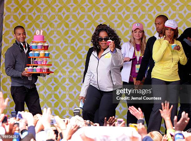 Media personality Oprah Winfrey holds up a cupcake in celebration of the completion of the "Live Your Best Life Walk" to celebrate O, The Oprah...