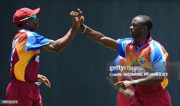 West Indian cricketers Dwayne Bravo and Kemar Roach celebrate the wicket of Indian cricketer Gautam Gambhir during the ICC World Twenty20 Super 8...