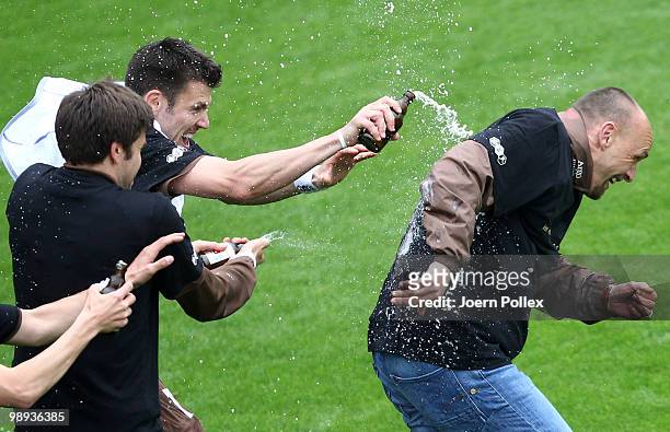 Head coach Holger Stanislawski of St. Pauli gets a beer shower after the Second Bundesliga match between FC St. Pauli and SC Paderborn at Millerntor...