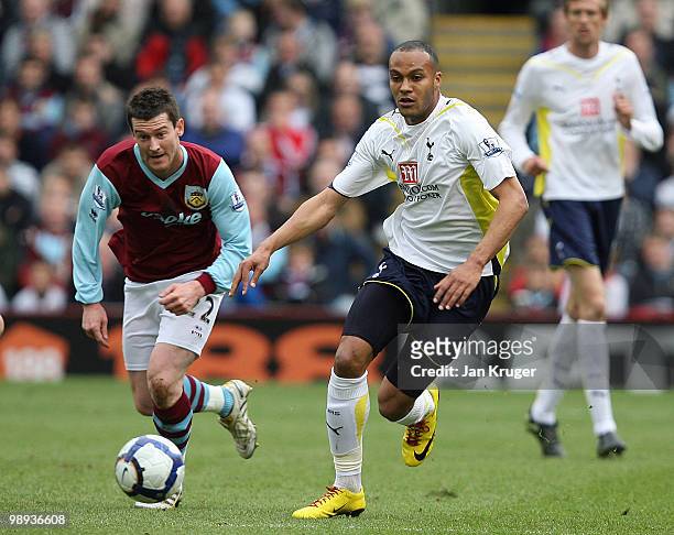 Younes Kaboul of Tottenham Hotspur and David Nugent of Burnley set off after a loose ball during the Barclays Premier League match between Burnley...