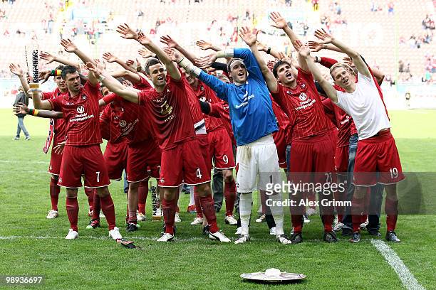 Player of Kaiserslautern celebrate with the championship trophy in front of their supporters after the Second Bundesliga match between 1. FC...