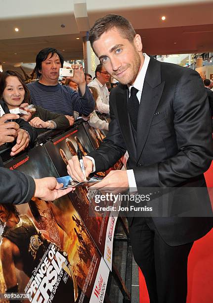 Actor Jake Gyllenhaal poses with a fan as he attends the 'Prince Of Persia: The Sands Of Time' world premiere at the Vue Westfield on May 9, 2010 in...