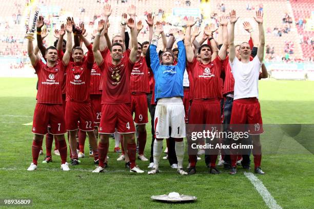 Player of Kaiserslautern celebrate with the championship trophy in front of their supporters after the Second Bundesliga match between 1. FC...