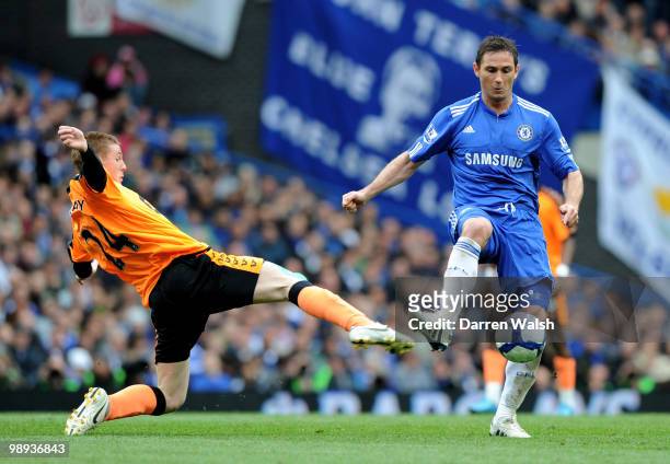 Frank Lampard of Chelsea is challenged by James McCarthy of Wigan during the Barclays Premier League match between Chelsea and Wigan Athletic at...