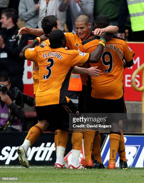 Adlene Guedioura of Wolves is congratulated by team mates after scoring their second goal during the Barclays Premier match between Wolverhampton...