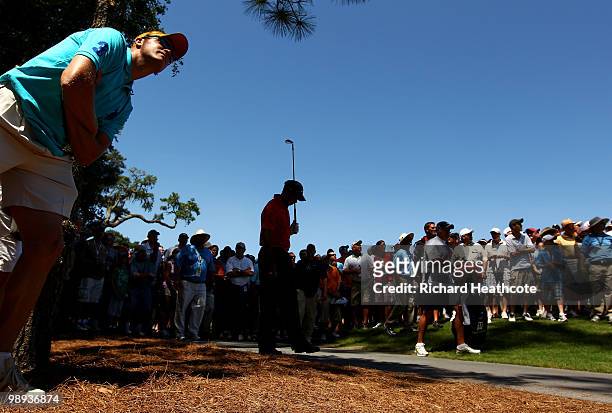 Tiger Woods plays an approach shot from the rough on the seventh hole, his last shot before withdrawing from the final round of THE PLAYERS...