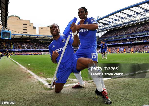 Didier Drogba of Chelsea celebrates with teammate Florent Malouda after completing his hat trick and scoring his team's seventh goal during the...