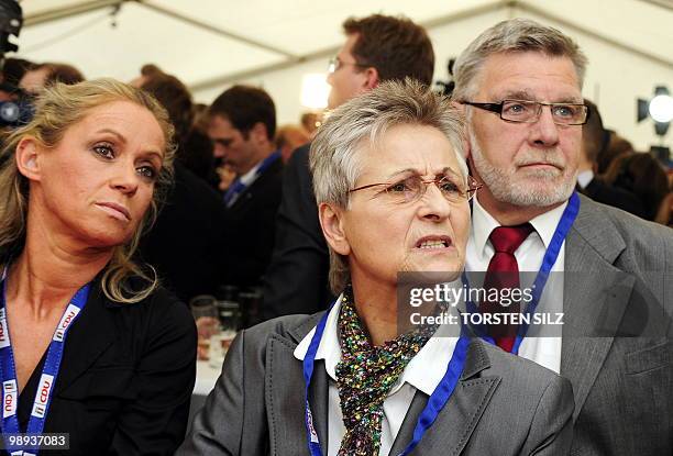 Supporters of Germany's Christian Democratic Union react as exit poll resuts are announced on state television at an election results party in the...