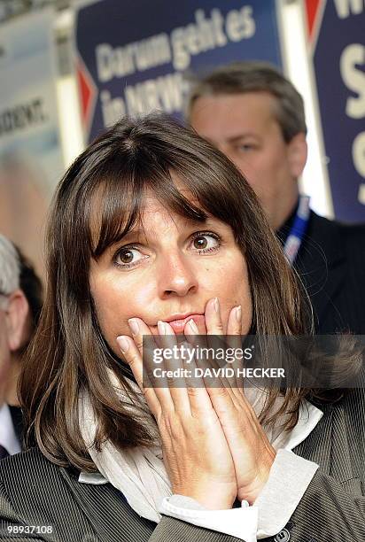 Supporter of Germany's Christian Democratic Union reacts as exit poll resuts are announced on state television at an election results party in the...