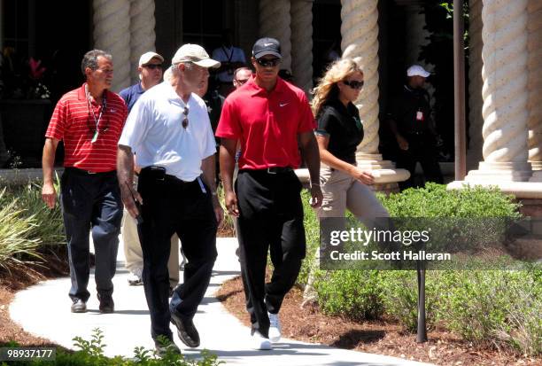 Tiger Woods leaves the clubhouse escorted by Joe Corless , the head of PGA TOUR security, after Tiger withdraws on the seventh hole due to a neck...