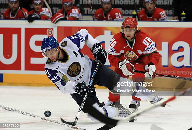 Yaroslav Chupris of Belarus and Dmitri Dudarev of Kazakhstan battle for the puck during the IIHF World Championship group A match between Slovakia...
