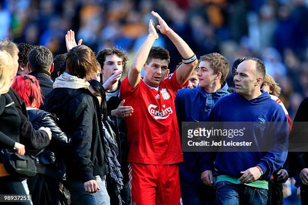 Surrounded by Hull City fans who have invaded the pitch at fulltime, Steven Gerrard of Liverpool makes his way to the away fans to applaud them...