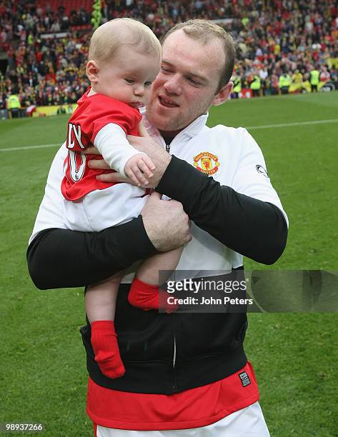 Wayne Rooney of Manchester United carries his son Kai on the lap of honour after the Barclays Premier League match between Manchester United and...