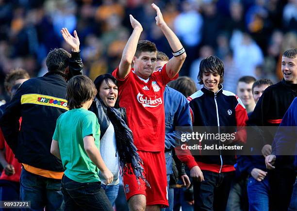 Surrounded by Hull City fans who have invaded the pitch at fulltime, Steven Gerrard of Liverpool makes his way to the away fans to applaud them...