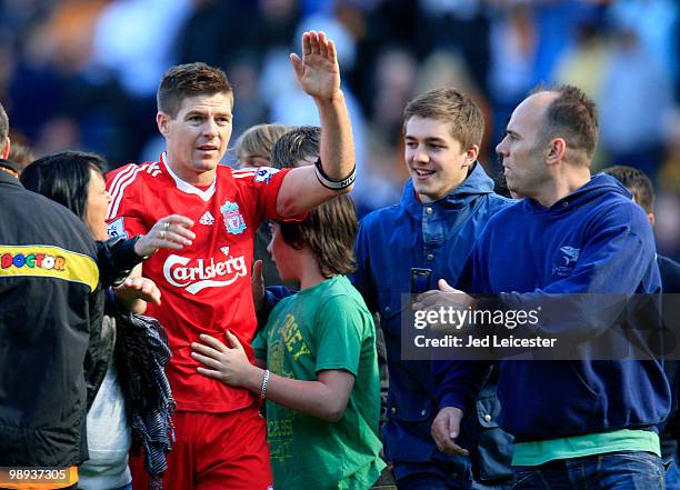 Surrounded by Hull City fans who have invaded the pitch at fulltime, Steven Gerrard of Liverpool makes his way to the away fans to applaud them...