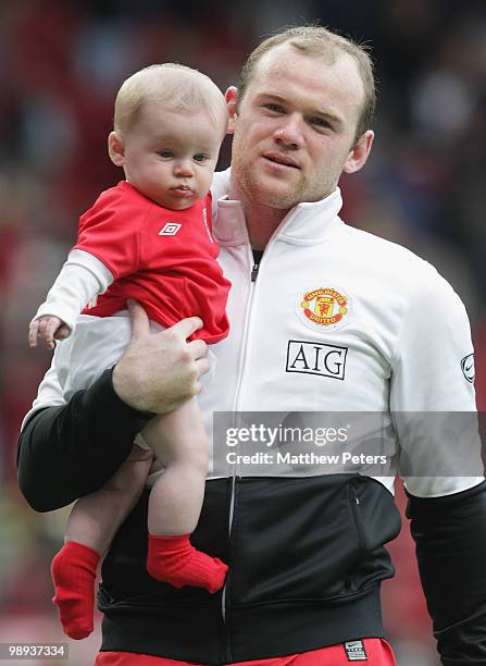 Wayne Rooney of Manchester United carries his son Kai on the lap of honour after the Barclays Premier League match between Manchester United and...