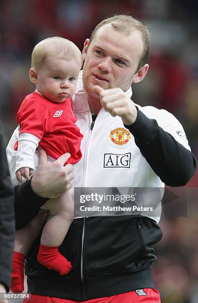 Wayne Rooney of Manchester United carries his son Kai on the lap of honour after the Barclays Premier League match between Manchester United and...