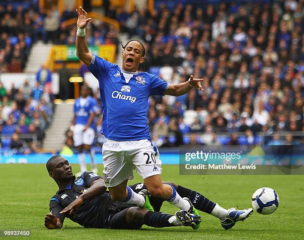 Steven Pienaar of Everton is tackled by Papa Bouba Diop of Porstmouth during the Barclays Premier League match between Everton and Portsmouth at...