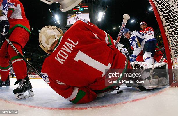 Vitali Koval, goalkeeper of Belarus saves the shot of Roman Starchenko of Kazakhstan battle for the puck during the IIHF World Championship group A...