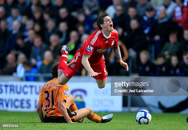 Daniel Agger of Liverpool is tacked by Daniel Atkinson of Hull City during the Barclays Premier League match between Hull City and Liverpool at the...