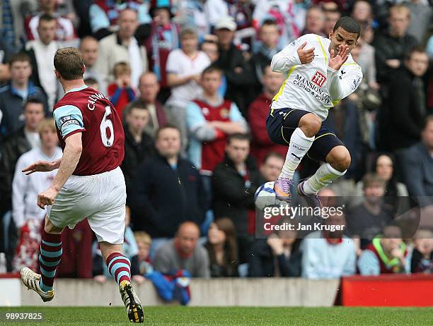 Aaron Lennon of Tottenham Hotspur takes evasive action as Stephen Caldwell of Burnley clear his lines during the Barclays Premier League match...