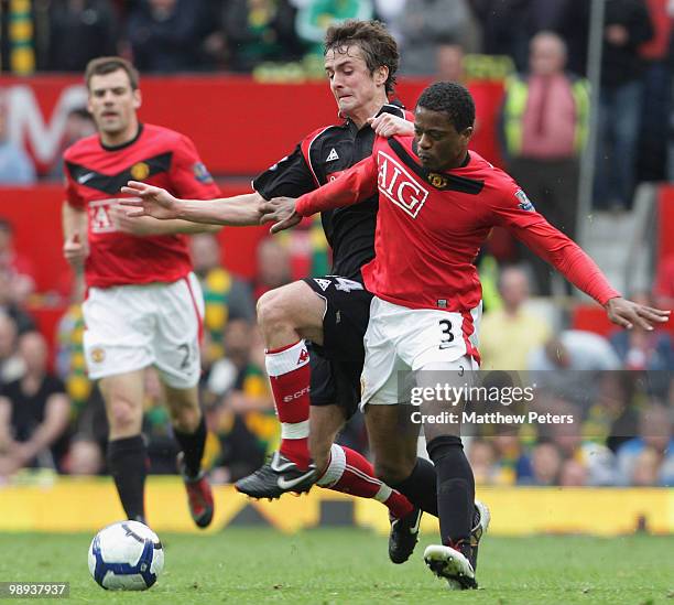 Patrice Evra of Manchester United tussles with Danny Pugh of Stoke City during the Barclays Premier League match between Manchester United and Stoke...